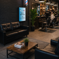 Barbershop with morden feel. Advertising screen from Canafied against the wall.